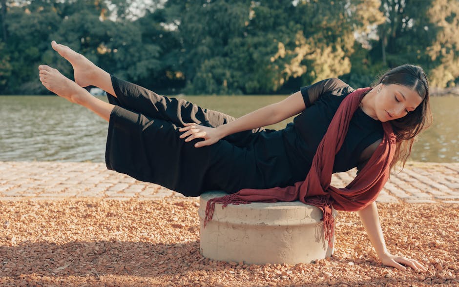Woman holding a tree pose in a sunlit room, embodying balance and grace